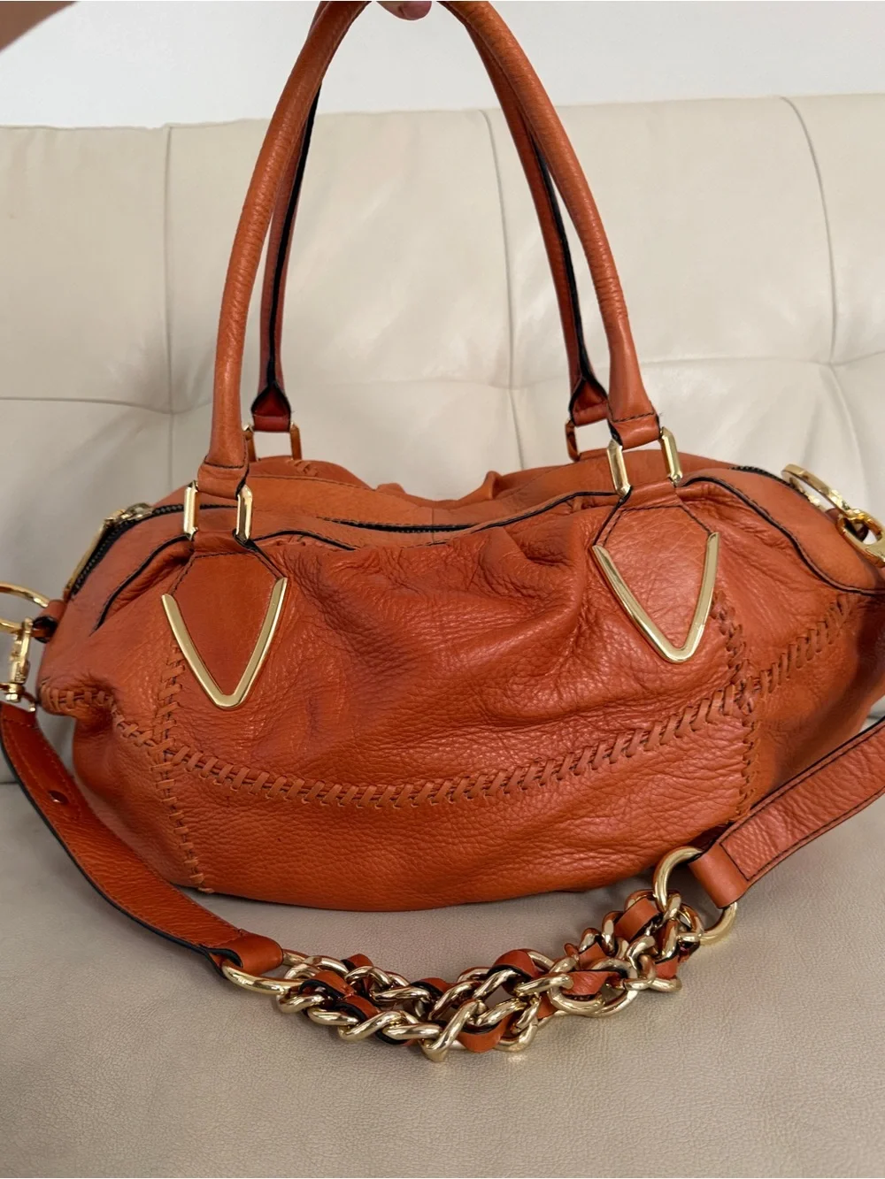 Orange leather handbag appears to be a slouchy style by orYany